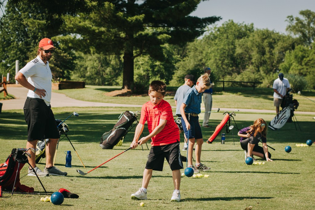 Youth golfers on the driving range