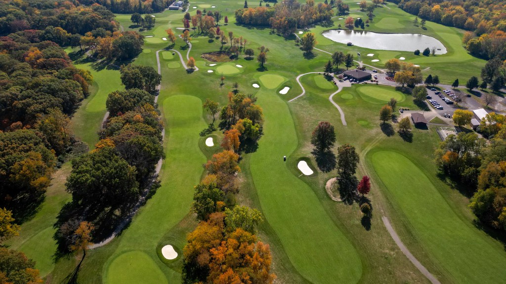 Aerial view of golf course with autumnal trees